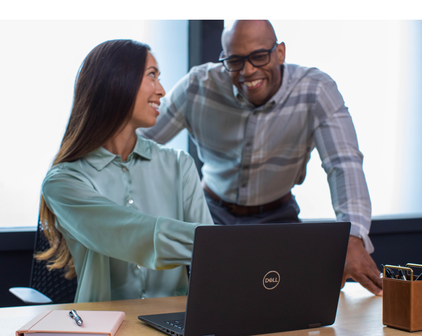Image of woman pointing to laptop with man